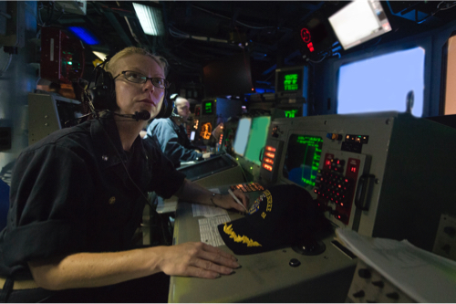 a technician aboard a naval ship at a computer